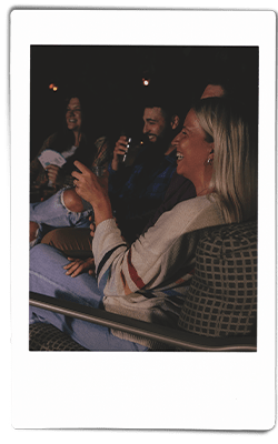 Instax picture of a group of friends sitting around a bonfire