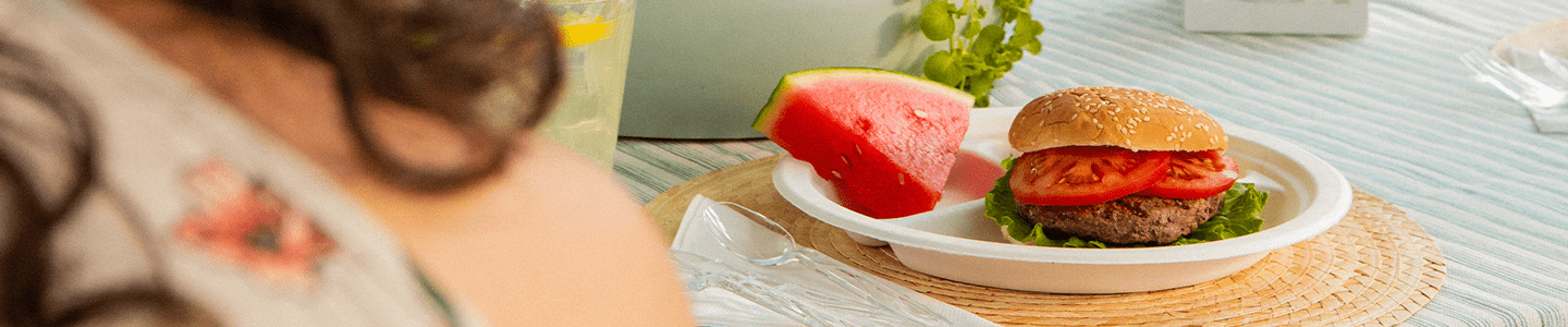 Hamburger and watermelon on a Chinet Classic plate