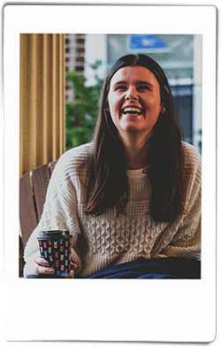 Woman laughing and holding a Chinet Comfort cup