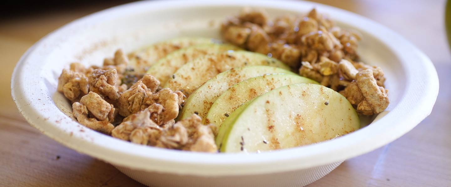 Apple and Yogurt with cinnamon in white disposable bowl