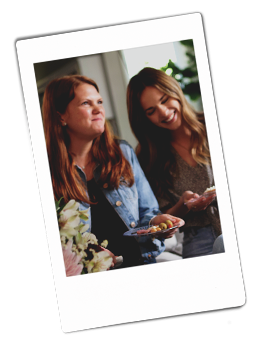 Instax picture of two women sitting on a couch laughing