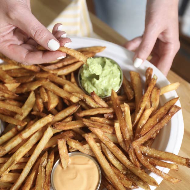 Crispy, homemade fries with sriracha mayo, avocado-cilantro sauce & beer cheese