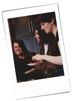 Instax picture of a group of women holding a Chinet Classic plates of appetizers