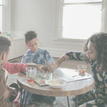 Mom and three children playing a board game