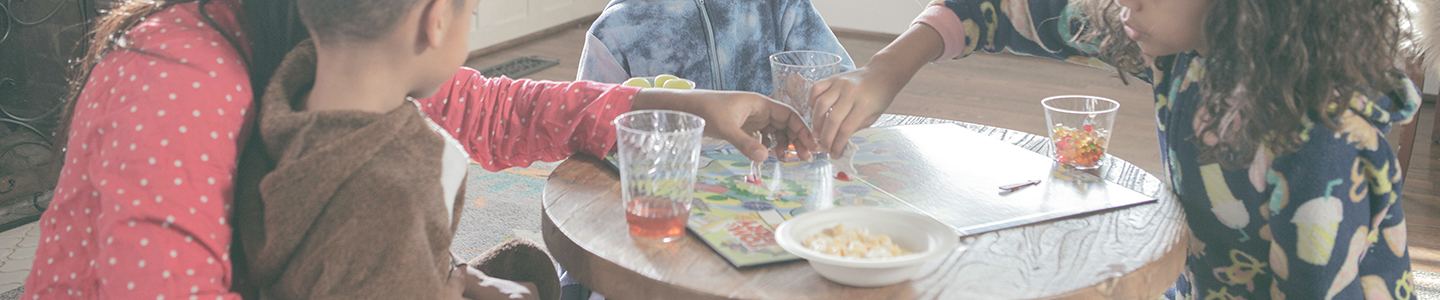 Mom and three children playing a board game