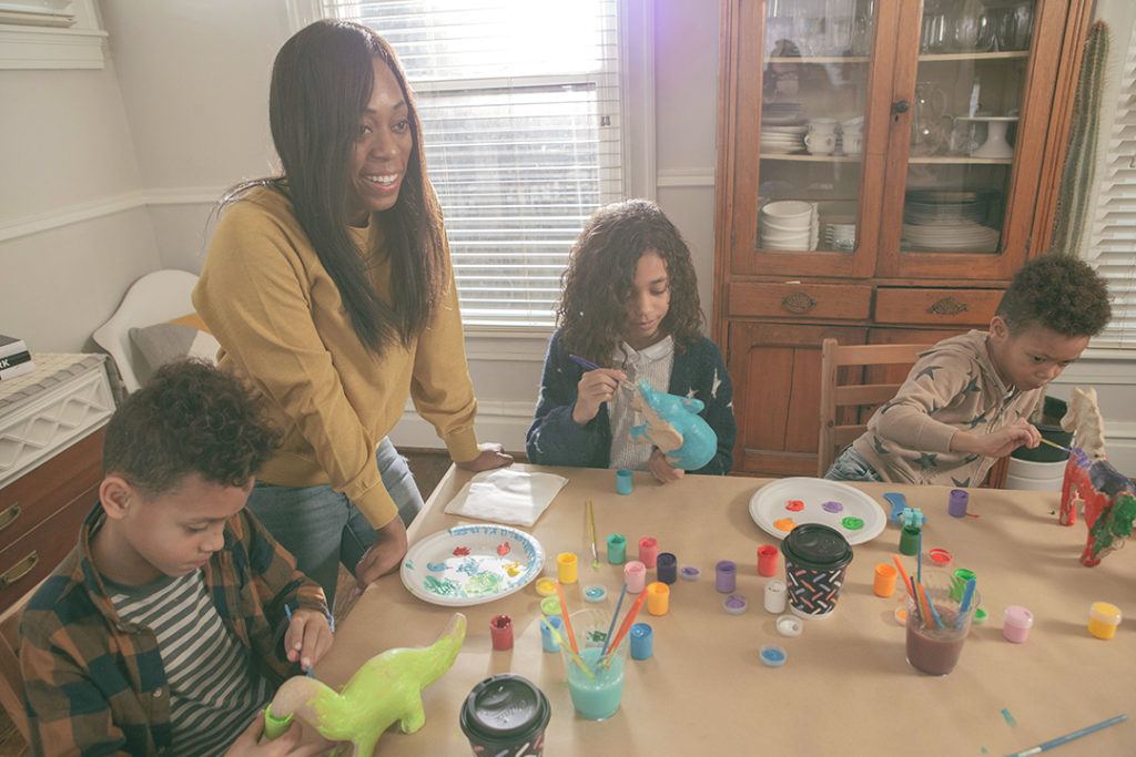 Mom and three children painting