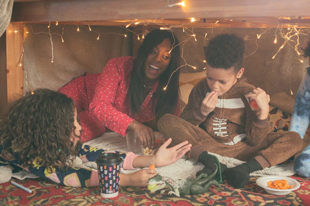 Mom and three children playing in a fort