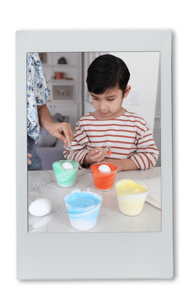 Instax of Mom & Son Dyeing Easter Eggs