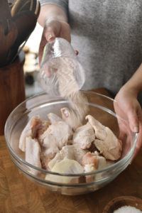 Prepping chicken wings in a bowl