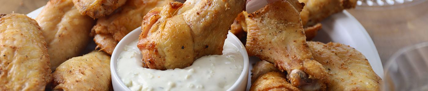 Chicken wing dipping in ranch
