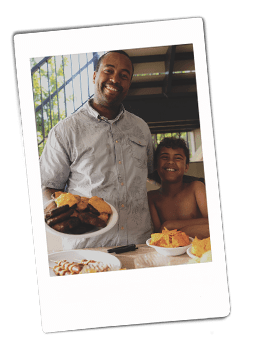 Instax picture of a father and son holding a Chinet Classic plate full of cheeseburgers