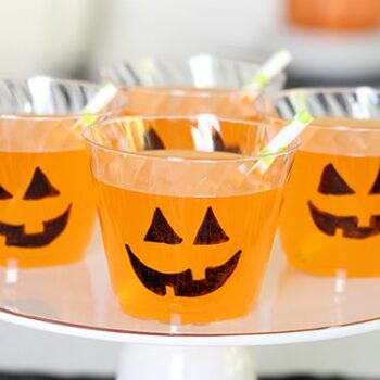 Chinet Crystal cups full of orange punch with jack o lantern faces