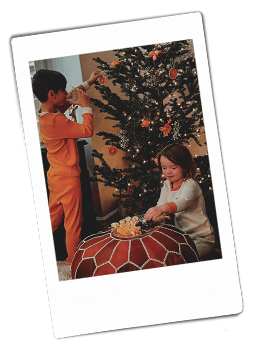 Instsax picture of a brother and sister decorating a Christmas tree