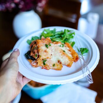 Slice of cheesy pasta bake served on a Chinet Classic lunch plate