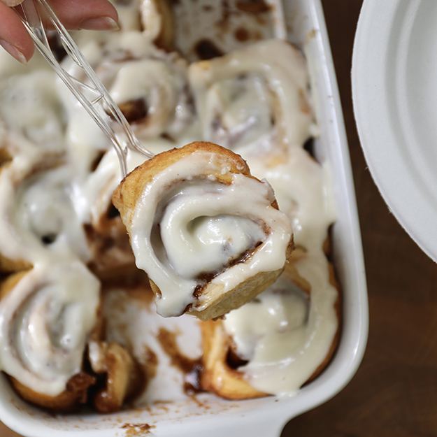 Baking dish of cinnamon rolls with icing