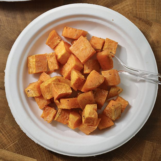 Cubed sweet potatoes on a Chinet Classic plate
