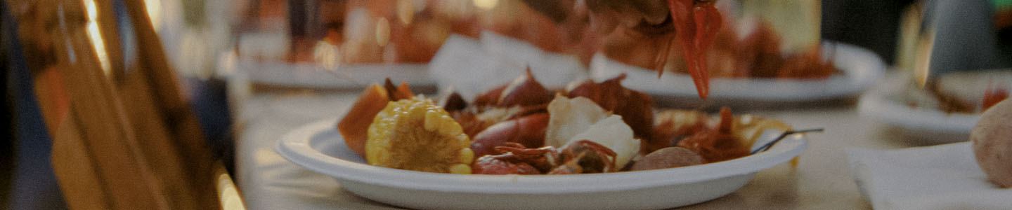Boiled crawfish and corn on a Chinet Classic® dinner plate