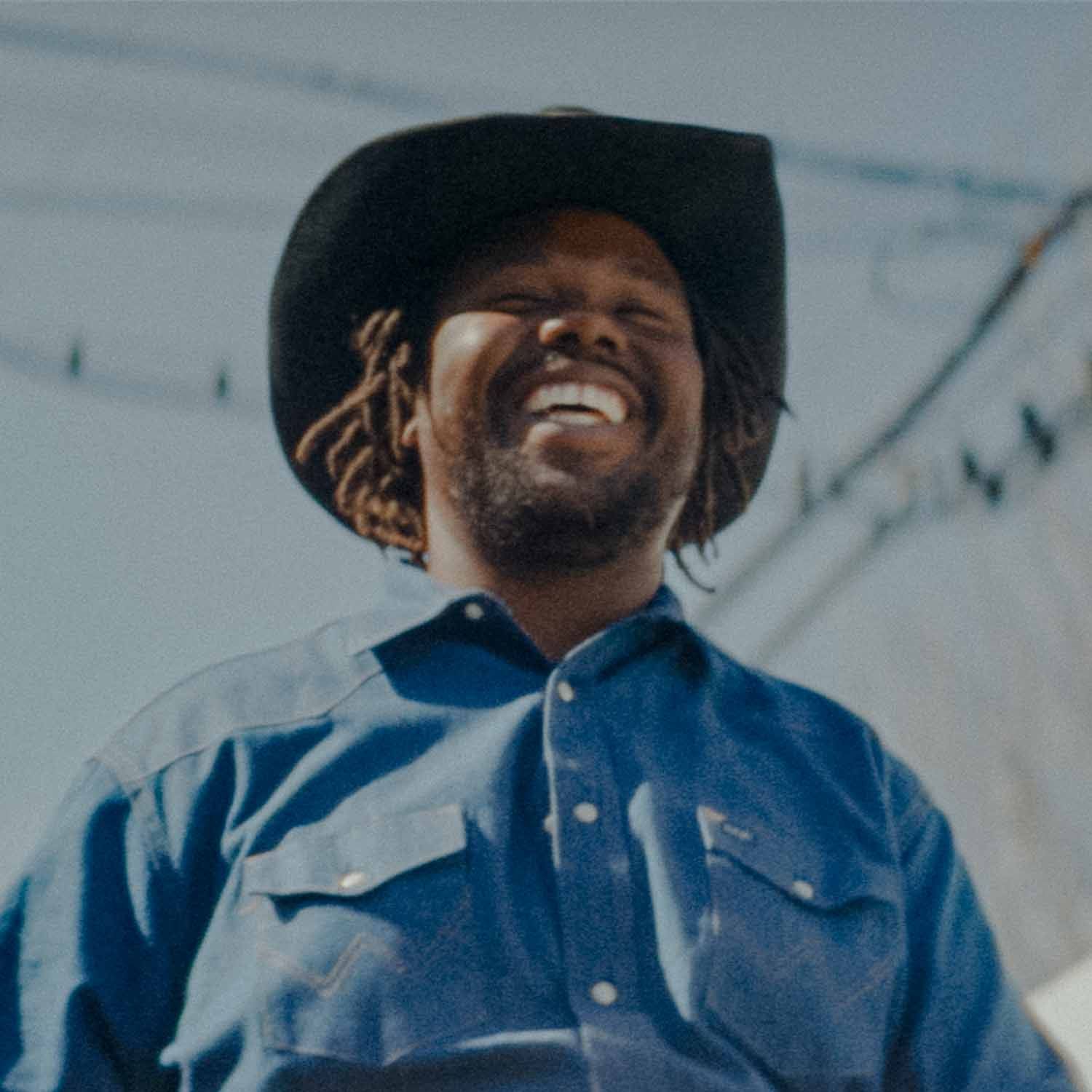 A man in cowboy hat smiling