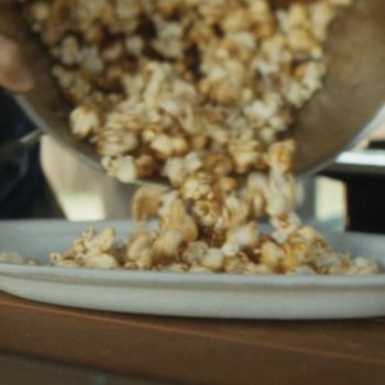 Candy cap mushroom kettle corn pouring onto Chinet Classic® platter