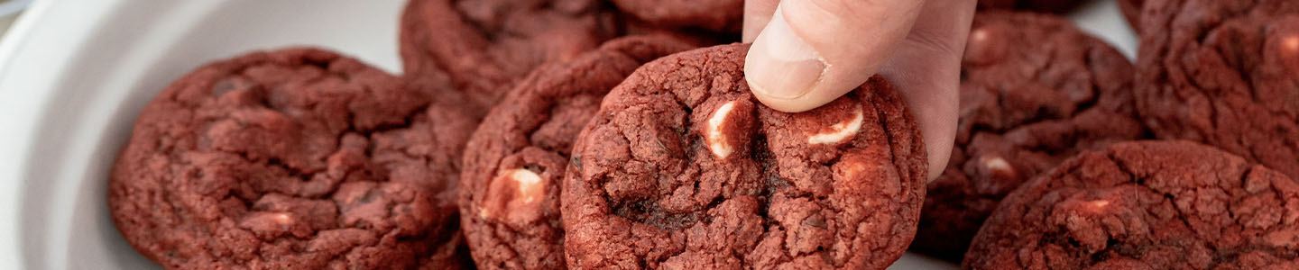Hand holding a red velvet cookie