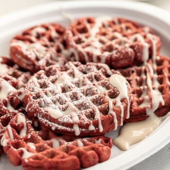 Red velvet waffles drizzled with a cream cheese glaze served on a Chinet Classic platter