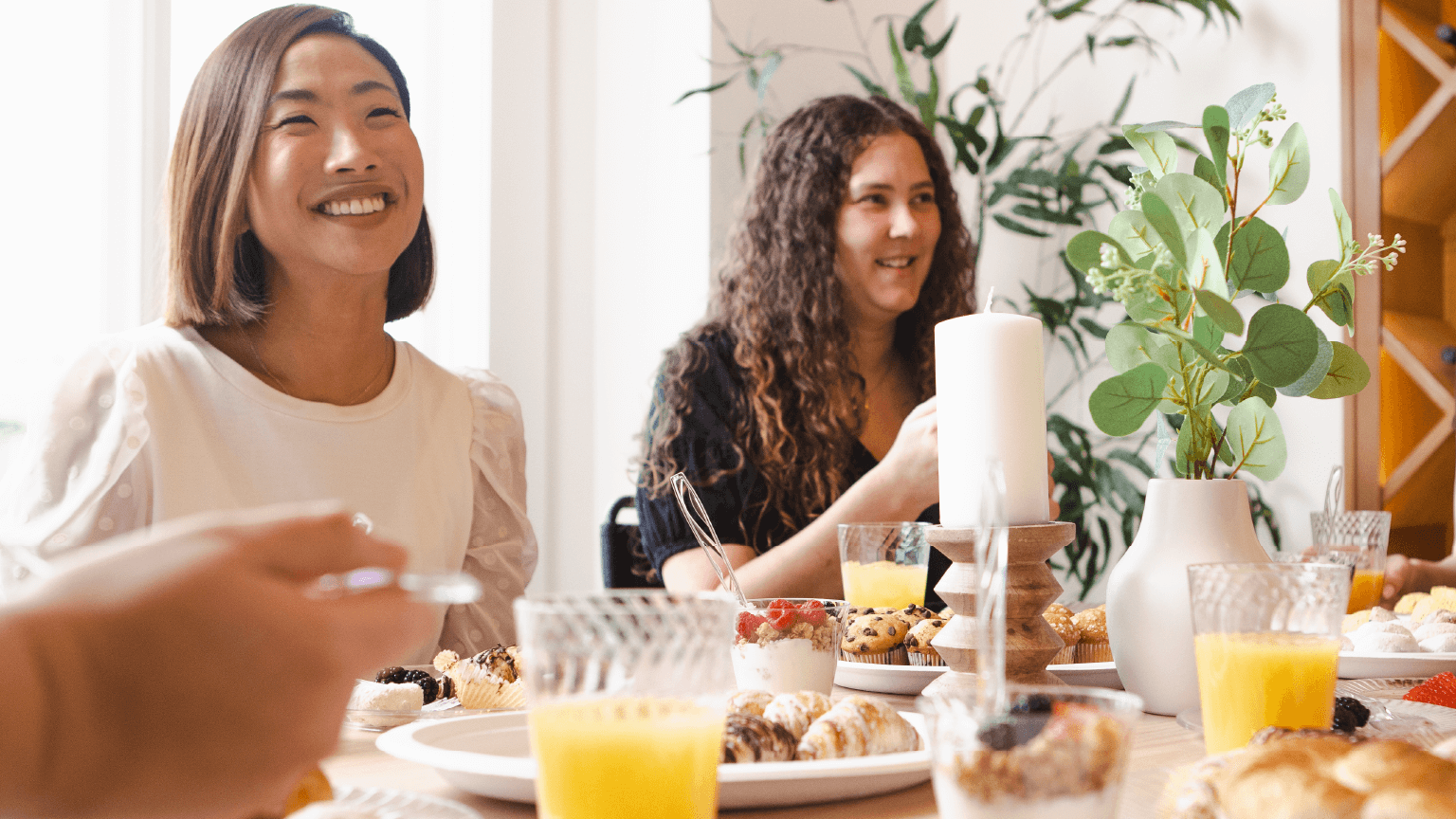 Woman sitting around a table eating brunch