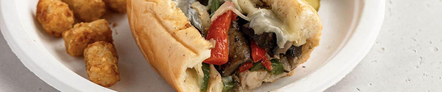 Chicken and mushroom cheesesteak served on a Chinet Classic plate