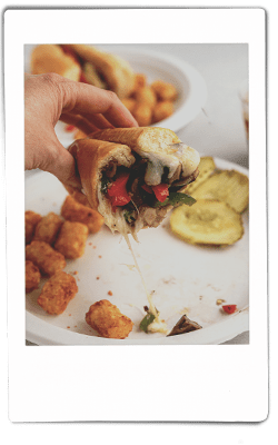 Instax picture of chicken and mushroom cheesesteak served on a Chinet Classic plate