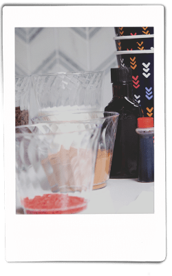 Instax picutre of red sprinkles in a Chinet Crystal 9oz cup