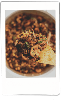Instax picture of mushrooms and blackbeans sautéing in a fry pan