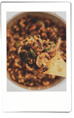 Instax picture of mushrooms and blackbeans sautéing in a fry pan