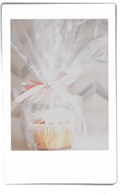 Instax picture of a cupcake in a Chinet Crystal 9oz cup wrapped in clear wrap
