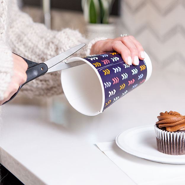 Woman cutting a Chinet Comfort cup