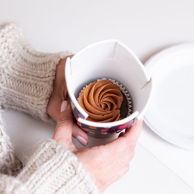 Woman holding a Chinet Comfort cup with a cupcake inside