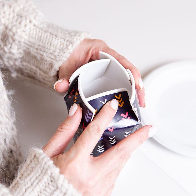 Woman folding a Chinet Comfort cup