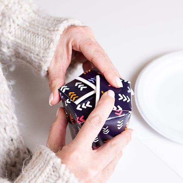 Woman folding a Chinet Comfort cup