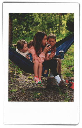 Woman and children sitting in a hammock holding Chinet Comfort® Cups