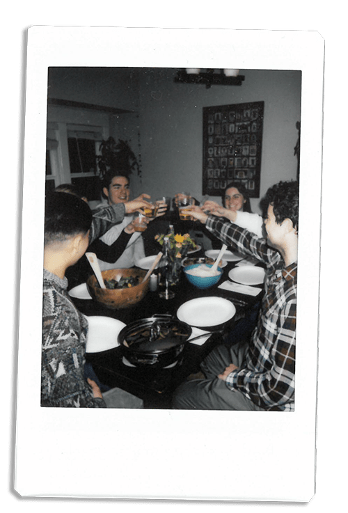 Instax picture of friends toasting at a table