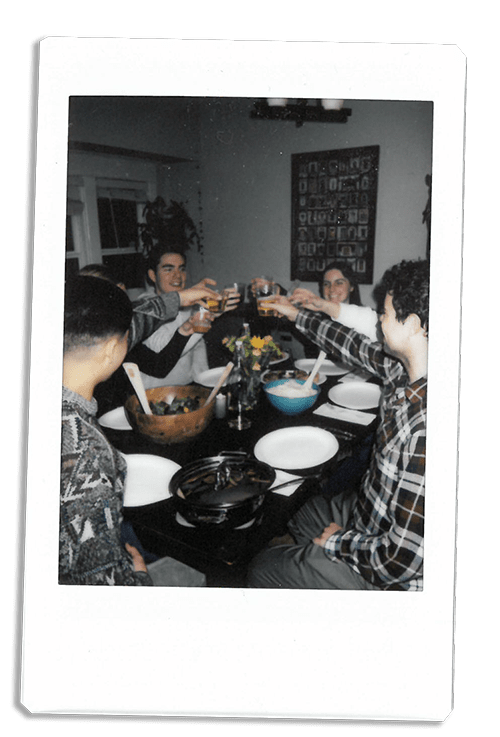 Instax picture of friends toasting at a table