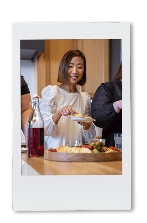 Women eating around a cheese board