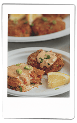 Instax picture of a crawfish cakes served on a Chinet Classic plate