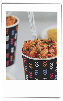 Instax picture of a crawfish jambalaya served in a Chinet Comfort cup