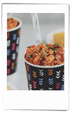 Instax picture of a crawfish jambalaya served in a Chinet Comfort cup