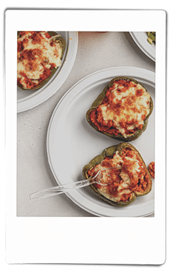 Instax picture of a crawfish stuffed bell peppers served on a Chinet Classic plate