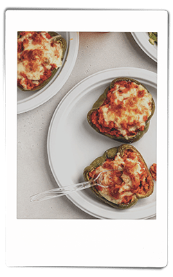 Instax picture of a crawfish stuffed bell peppers served on a Chinet Classic plate