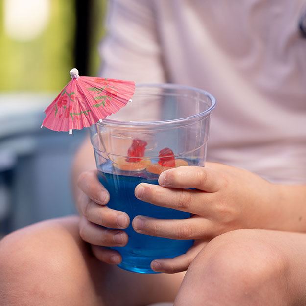 Young boy holding a cup of blue Jell-O