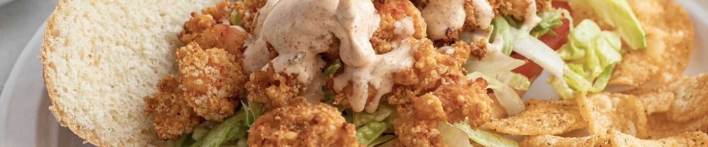 Crawfish po-boy served on a Chinet Classic plate
