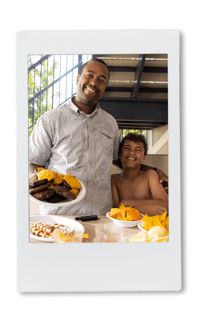 Instax picture of a father and son serving hamburgers