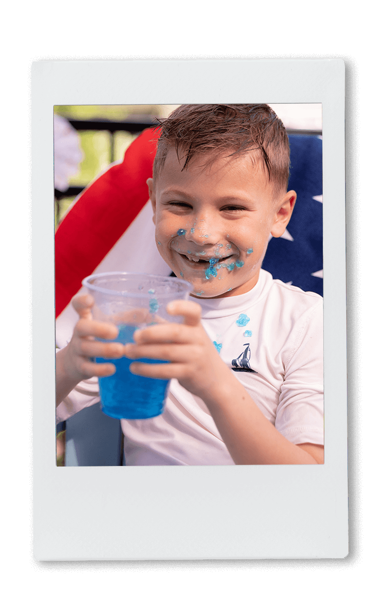 Instax picture of a young boy eating a blue Jell-O cup