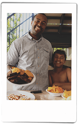 Instax picture of a father and son serving hamburgers